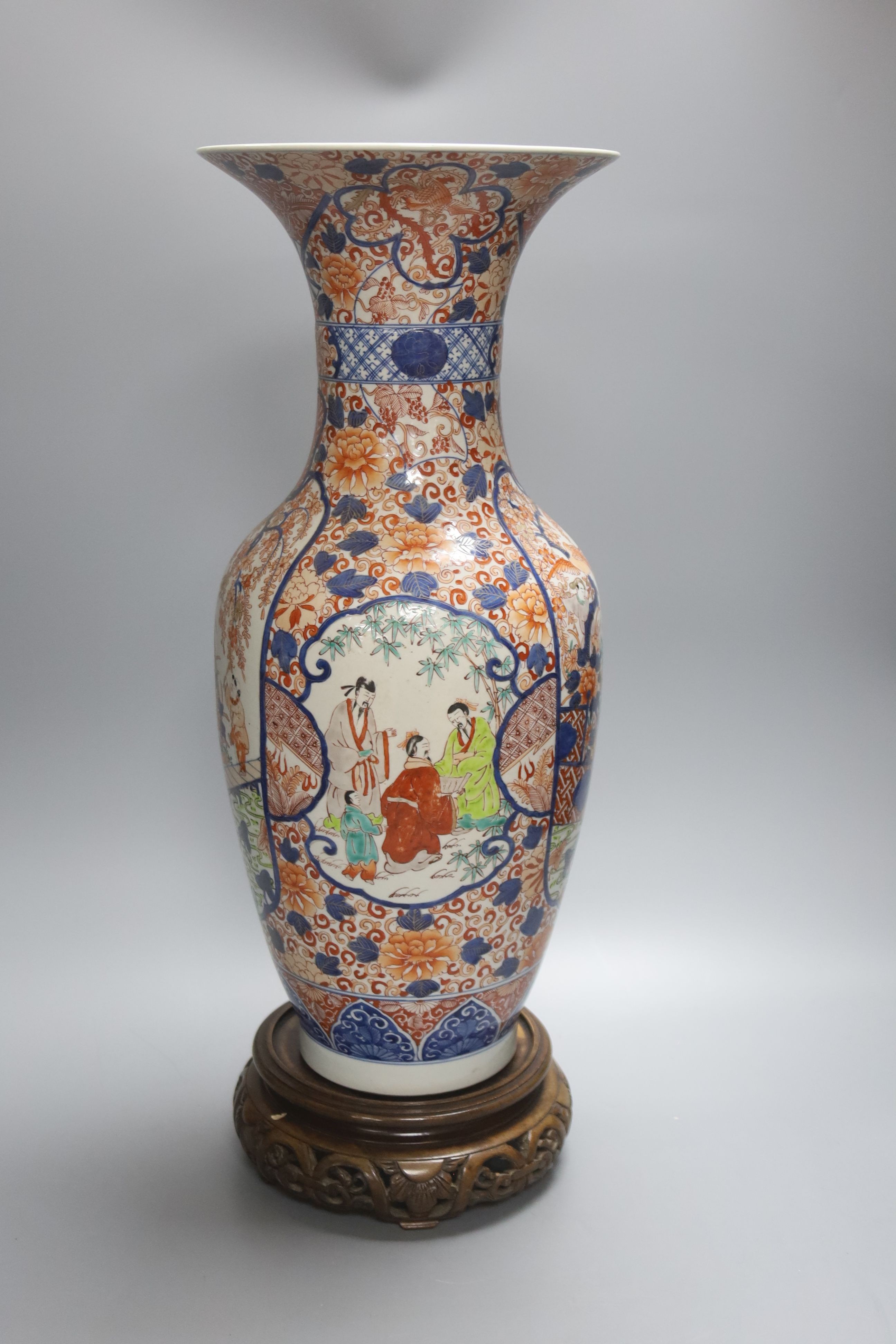 A large 20th century Japanese Arita porcelain vase, wood stand, restored 50cm